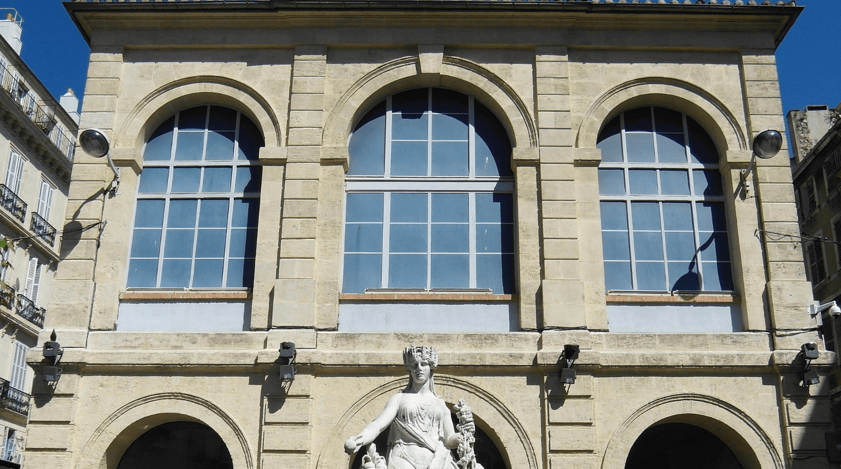Entrée de métro et tram de l'arrêt Noailles avec sa statue dans le quartier de Noailles.